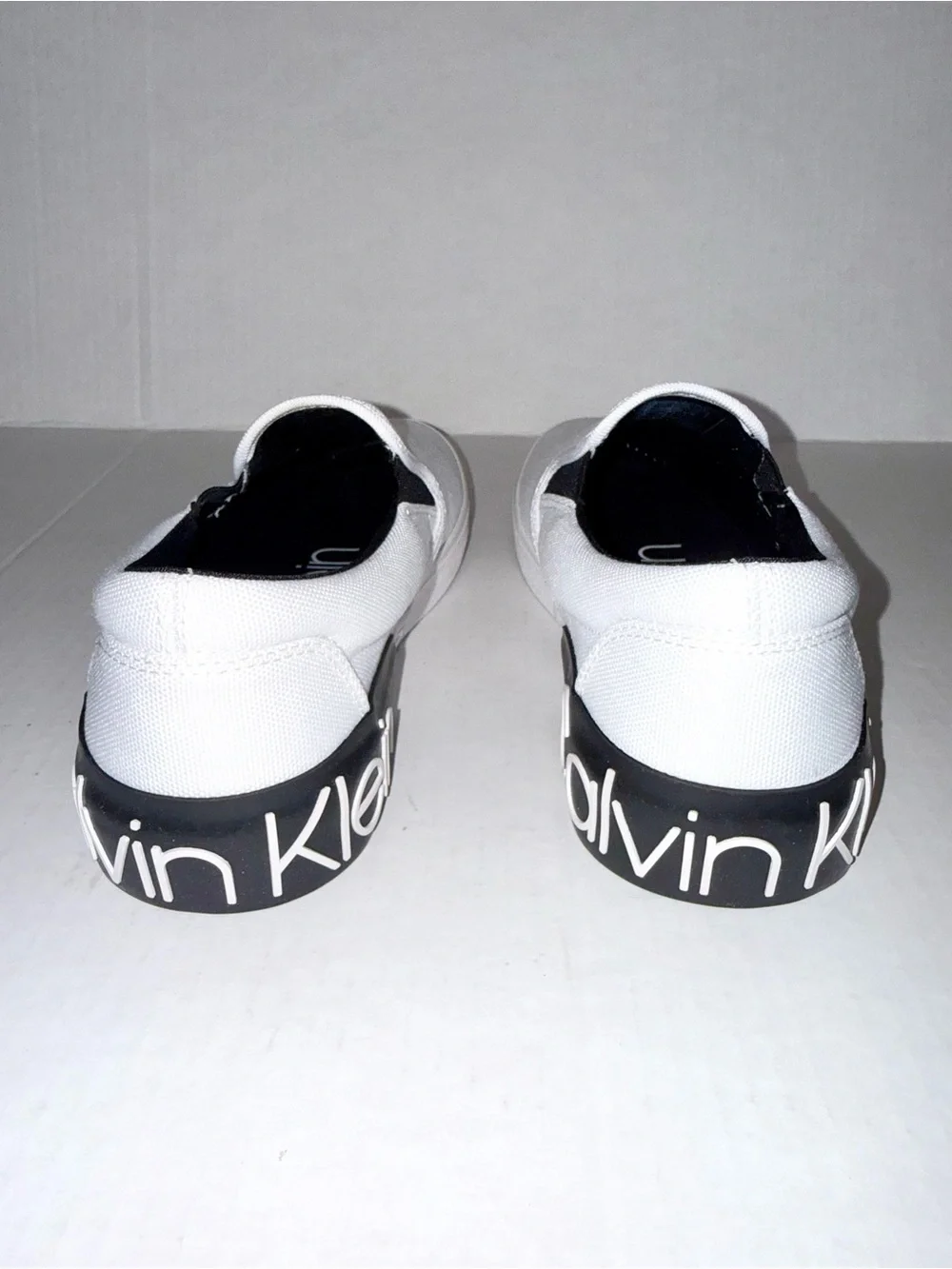 Calvin Klein White Canvas Slip-On Loafers with Black Heel Logo Accent